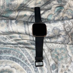 Fitbit Versa 2 watch in rose gold with three extra bands.